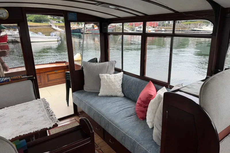 Slide: The Image of Interior of a 1940 Elco Cruisette boat with cozy seating and waterfront view. - 6