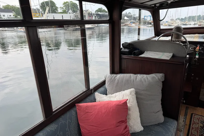 Slide: The Image of Interior of a 1940 Elco Cruisette boat with cushions and waterfront view. - 7