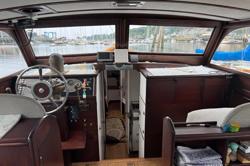 Slide: The Image of Interior view of a 1940 Elco Cruisette boat with vintage steering wheel and dashboard. - 9