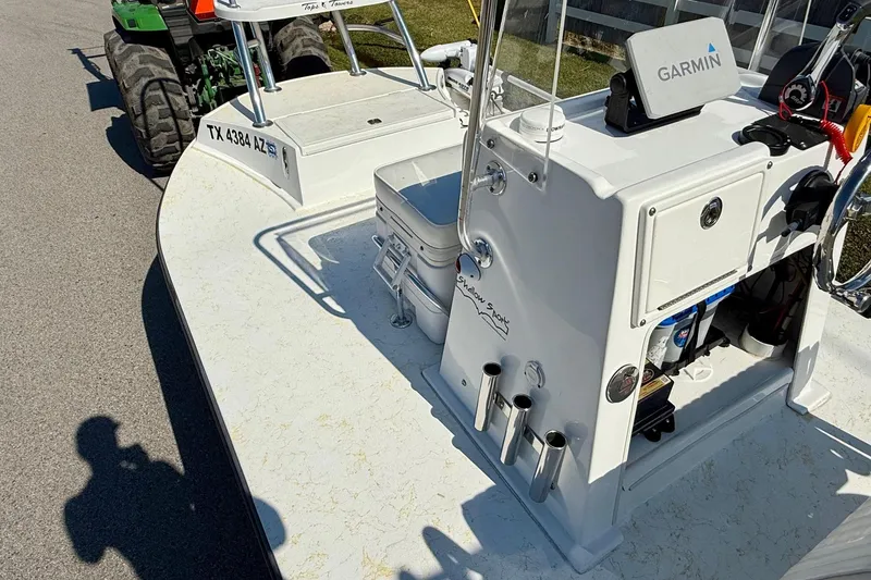 Slide: The Image of 2010 Shallow Sport 15 Classic boat with Garmin equipment, parked on a sunny day. - 11
