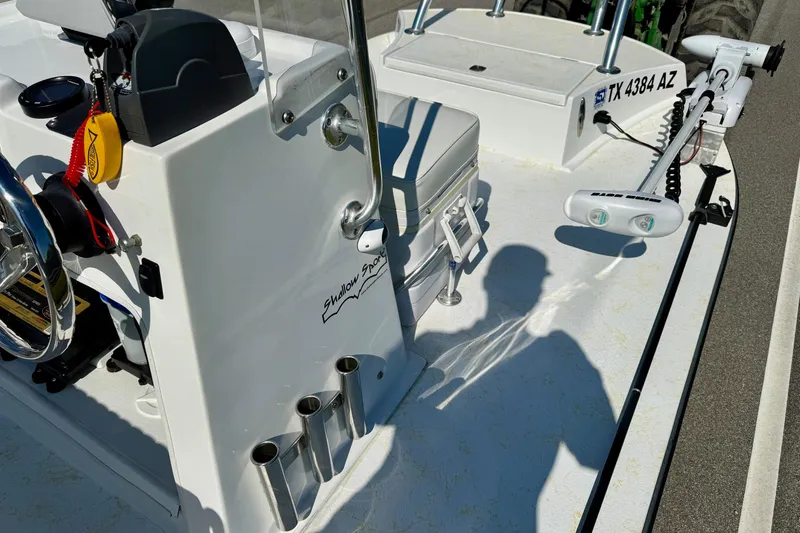 Slide: The Image of 2010 Shallow Sport 15 Classic boat interior with steering wheel and equipment. - 13