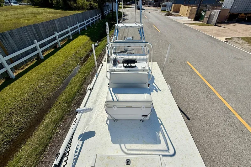 Slide: The Image of 2010 Shallow Sport 15 Classic boat on road, viewed from above, near grassy area. - 14