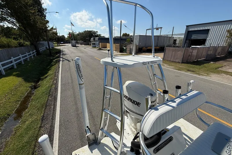 Slide: The Image of 2010 Shallow Sport 15 Classic boat with Evinrude motor on a sunny street. - 17