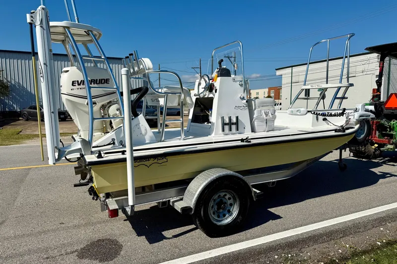 Slide: The Image of 2010 Shallow Sport 15 Classic boat on trailer with Evinrude engine, parked outdoors. - 4