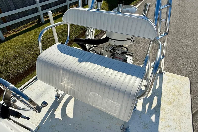 Slide: The Image of 2010 Shallow Sport 15 Classic boat with white cushioned seating and steering wheel. - 9