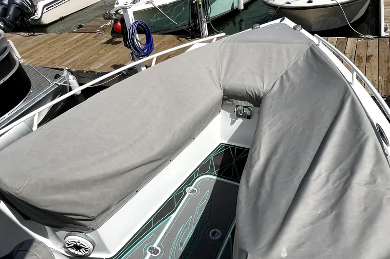 Slide: The Image of 2021 Glasstream 255 Pro-XS boat with gray cover docked at marina. - 10