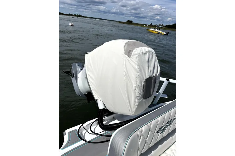 Slide: The Image of 2021 Glasstream 255 Pro-XS boat with covered outboard motor on water. - 14