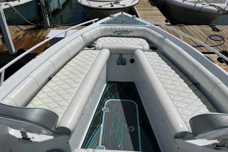 Slide: The Image of 2021 Glasstream 255 Pro-XS boat interior with white quilted seating and decorative flooring. - 29