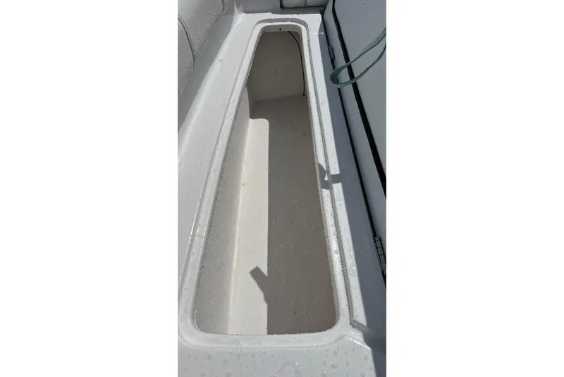 Slide: The Image of Storage compartment of 2021 Glasstream 255 Pro-XS boat, featuring a sleek, white interior. - 30