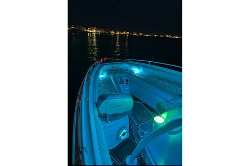 Slide: The Image of 2021 Glasstream 255 Pro-XS boat illuminated at night on calm waters. - 33