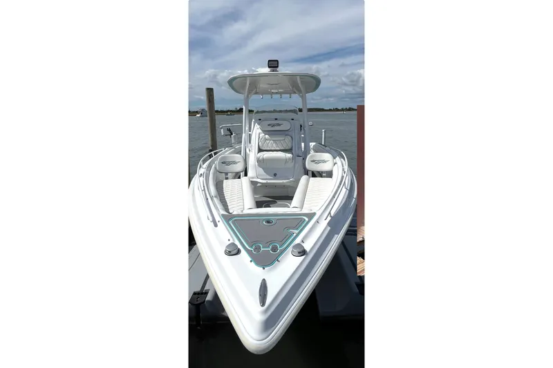Slide: The Image of 2021 Glasstream 255 Pro-XS boat docked, showcasing sleek design and spacious seating. - 6
