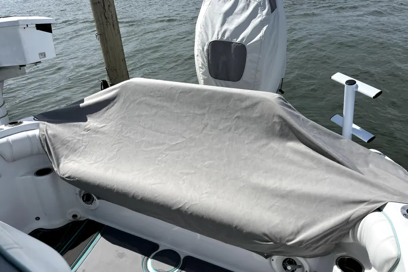 Slide: The Image of 2021 Glasstream 255 Pro-XS boat with covered seating area, docked by the water. - 9