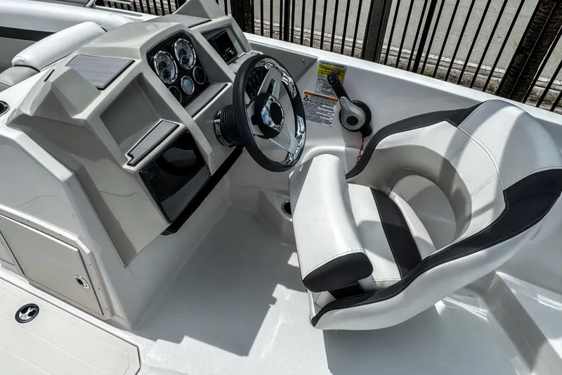 Slide: The Image of 2024 Starcraft SVX 211 OB boat cockpit with steering wheel and modern dashboard. - 9