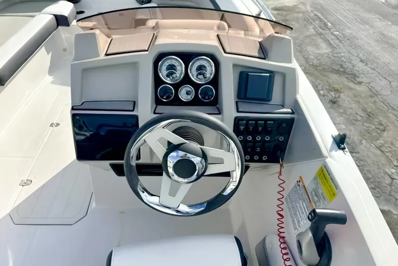 Slide: The Image of 2024 Starcraft SVX 211 OB boat dashboard with steering wheel and control panel. - 4