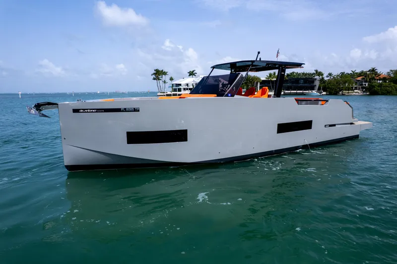 The Image of 2023 De Antonio Yachts D50 cruising on calm waters, showcasing sleek design and modern features. - 0