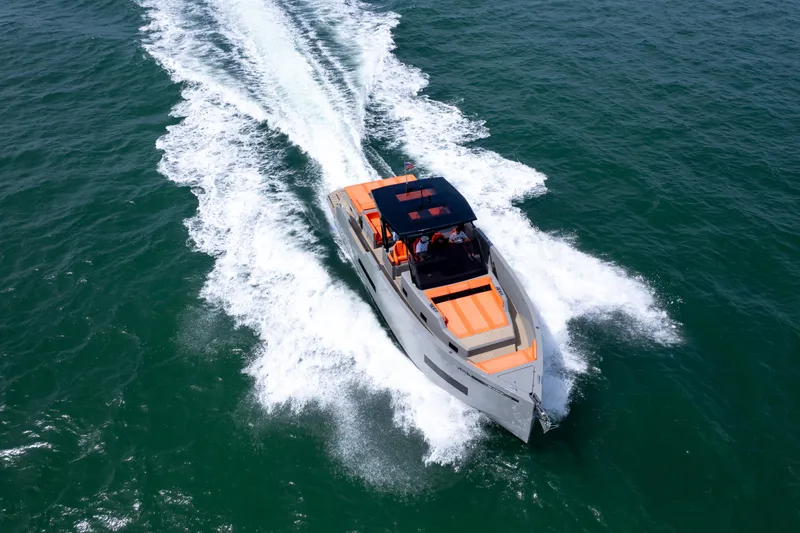 Slide: The Image of 2023 De Antonio Yachts D50 cruising on open water, showcasing sleek design and performance. - 11