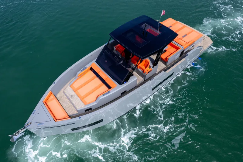 Slide: The Image of 2023 De Antonio Yachts D50 cruising on water, featuring sleek design and vibrant orange seating. - 15