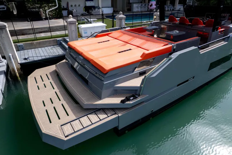 Slide: The Image of 2023 De Antonio Yachts D50 docked, featuring sleek design and vibrant orange seating. - 18