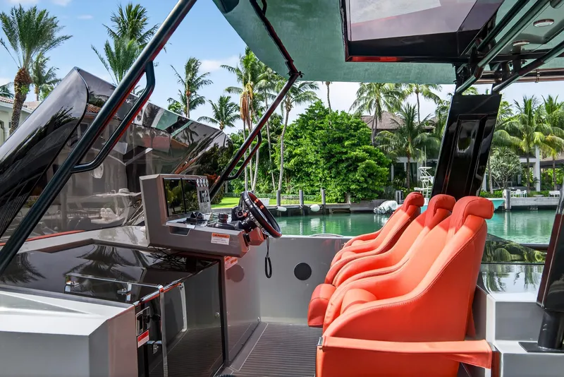 Slide: The Image of 2023 De Antonio Yachts D50 cockpit with vibrant orange seats and modern controls. - 20