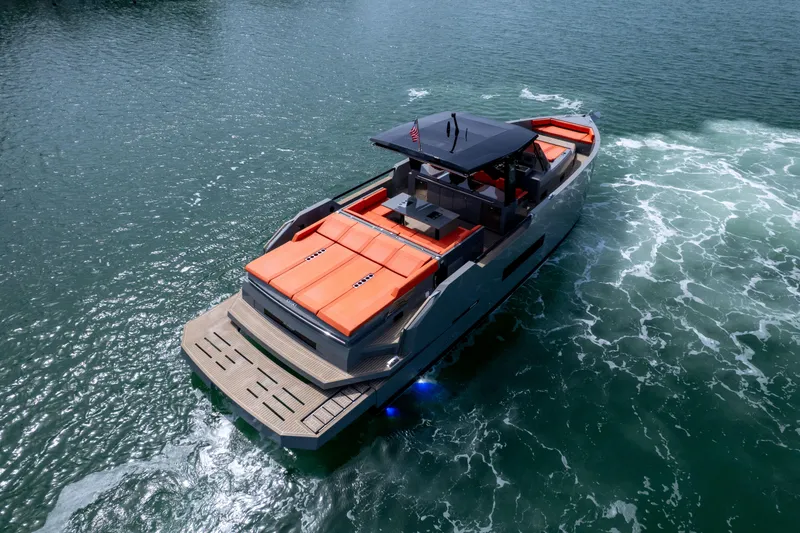 Slide: The Image of 2023 De Antonio Yachts D50 cruising on water, featuring sleek design and vibrant orange seating. - 24