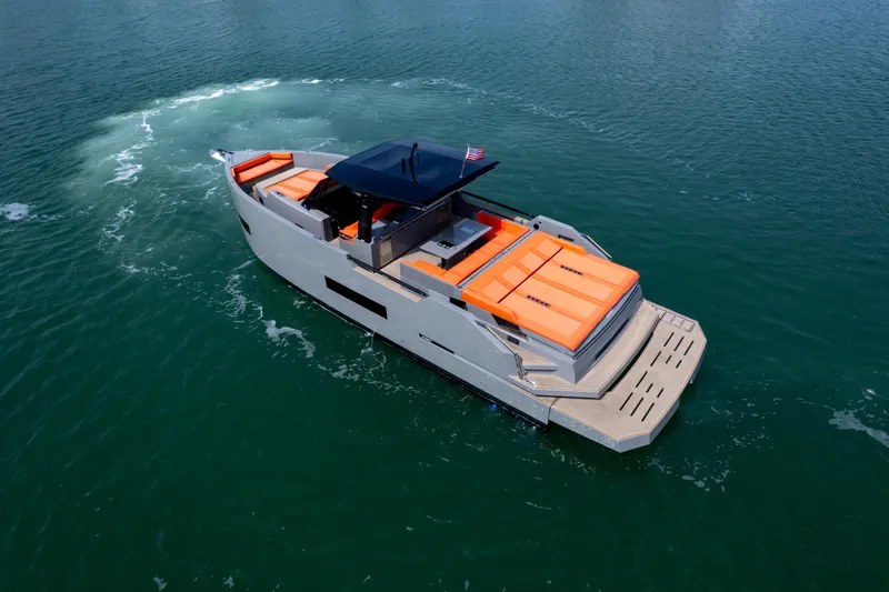 Slide: The Image of 2023 De Antonio Yachts D50 cruising on open water with vibrant orange seating. - 25