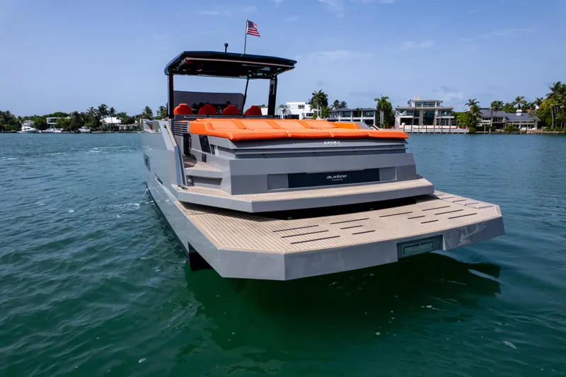 Slide: The Image of 2023 De Antonio Yachts D50 luxury yacht on water, featuring sleek design and vibrant seating. - 28