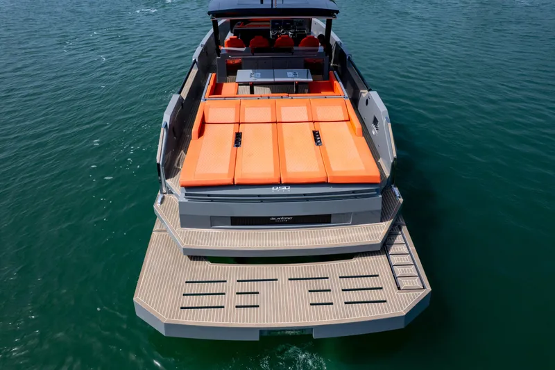 Slide: The Image of 2023 De Antonio Yachts D50 with orange sunbeds, sleek design, and spacious deck on the water. - 29