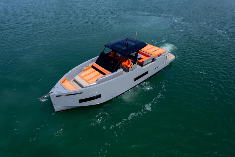 Slide: The Image of 2023 De Antonio Yachts D50 cruising on open water, featuring sleek design and vibrant orange seating. - 3