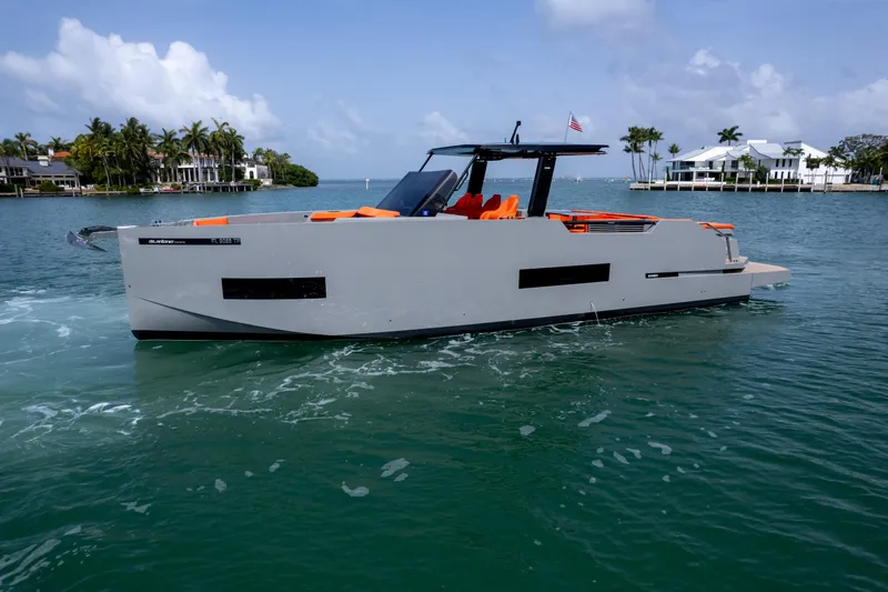 Slide: The Image of 2023 De Antonio Yachts D50 cruising in a scenic coastal area with modern design. - 4