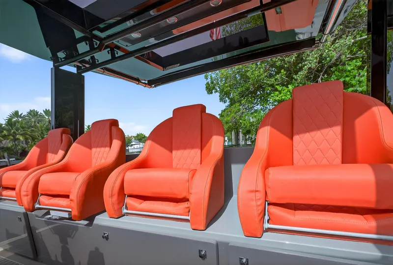 Slide: The Image of Luxurious orange seats on 2023 De Antonio Yachts D50, under sleek canopy, surrounded by greenery. - 42