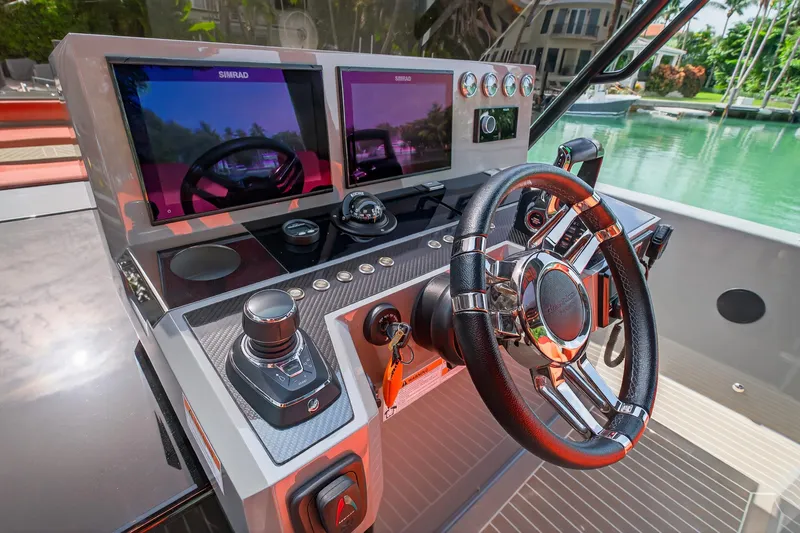 Slide: The Image of 2023 De Antonio Yachts D50 helm with dual Simrad displays and sleek steering wheel. - 46