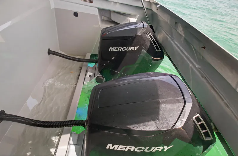 Slide: The Image of Twin Mercury outboard engines on a 2023 De Antonio Yachts D50, in clear water. - 49