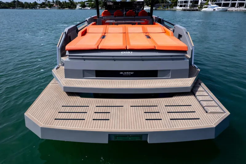 Slide: The Image of 2023 De Antonio Yachts D50 with orange sunbeds and spacious deck on the water. - 5
