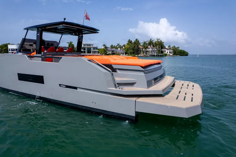 Slide: The Image of 2023 De Antonio Yachts D50 luxury yacht on water, featuring sleek design and vibrant orange seating. - 6