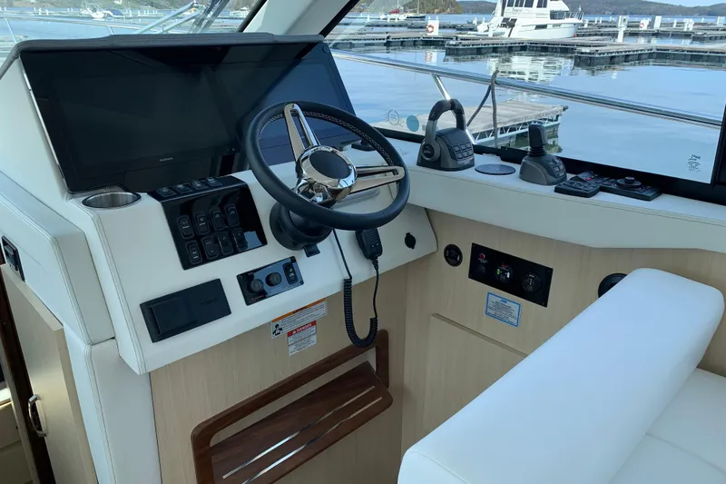 Slide: The Image of Helm of 2025 Regal 38 Grande Coupe with modern controls and navigation equipment. - 10