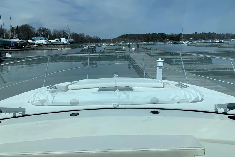 Slide: The Image of 2025 Regal 38 Grande Coupe yacht docked at a serene marina. - 12