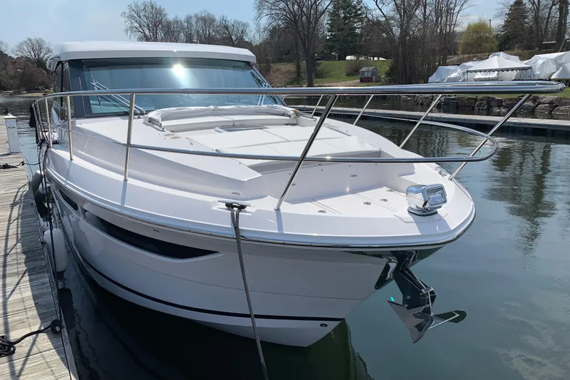 Slide: The Image of 2025 Regal 38 Grande Coupe yacht docked on a calm waterway. - 3