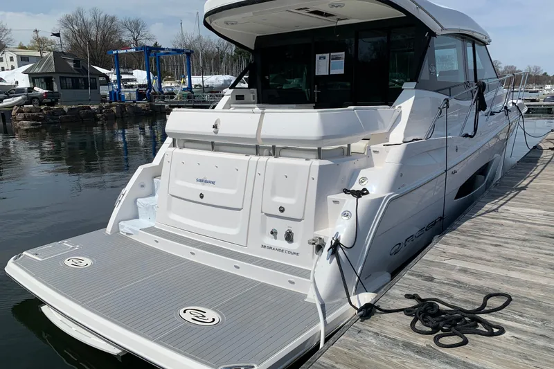 Slide: The Image of 2025 Regal 38 Grande Coupe yacht docked at marina, rear view. - 4