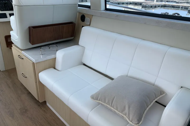 Slide: The Image of Luxurious interior of 2025 Regal 38 Grande Coupe with white seating and wooden accents. - 8