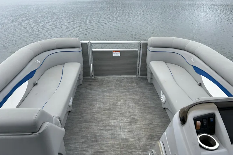 Slide: The Image of 2023 Bennington 22 SSR pontoon boat interior with gray seating and lake view. - 12