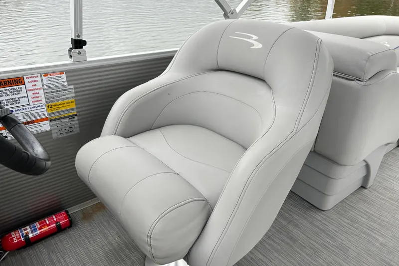 Slide: The Image of 2023 Bennington 22 SSR boat seat with safety labels and fire extinguisher. - 14