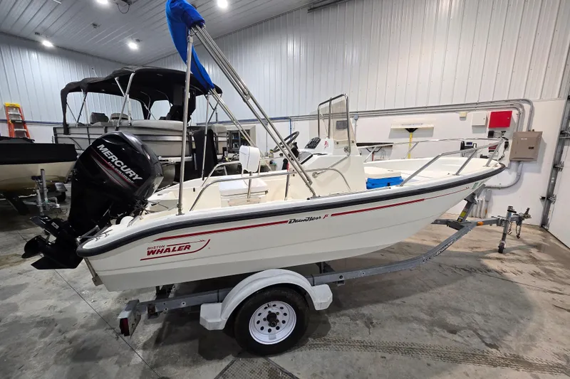 Slide: The Image of 1999 Boston Whaler Dauntless 14 boat on trailer in indoor storage. - 11