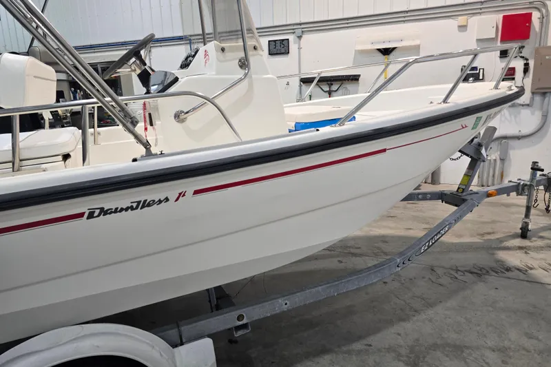 Slide: The Image of 1999 Boston Whaler Dauntless 14 boat on trailer in indoor storage. - 15