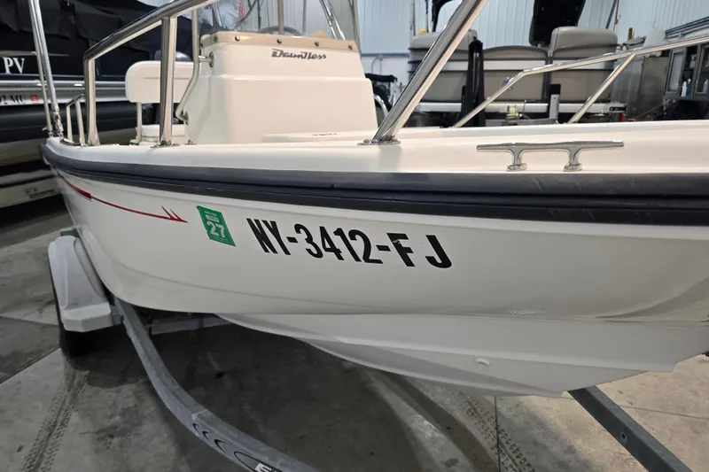Slide: The Image of 1999 Boston Whaler Dauntless 14 boat on trailer, registration number visible. - 16