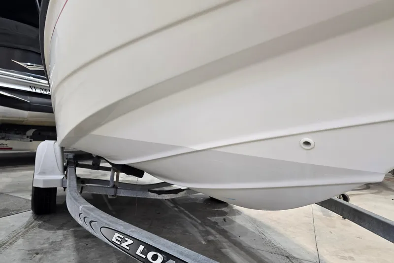 Slide: The Image of 1999 Boston Whaler Dauntless 14 boat on trailer, showcasing hull design. - 17