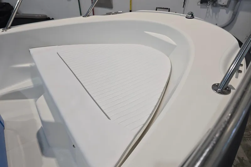 Slide: The Image of 1999 Boston Whaler Dauntless 14 boat interior, featuring a clean, white deck and stainless steel fittings. - 19