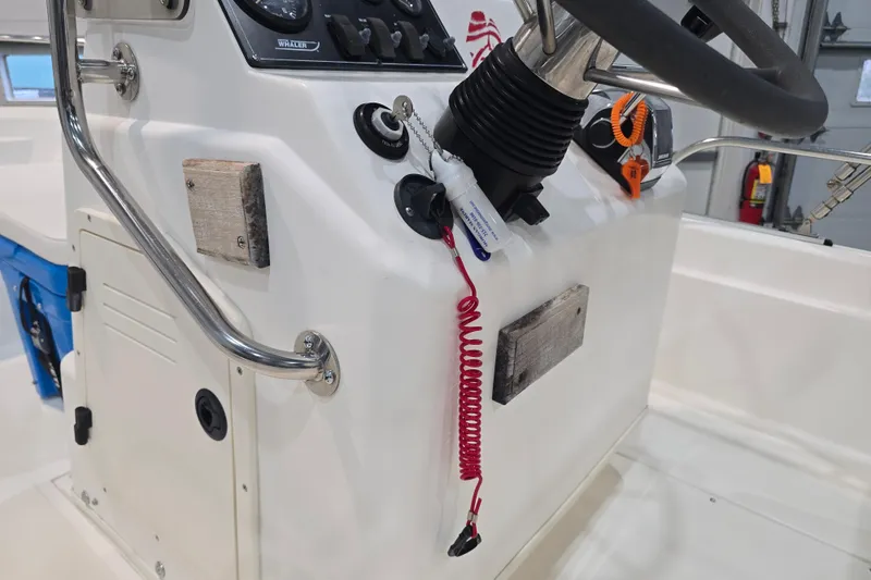 Slide: The Image of 1999 Boston Whaler Dauntless 14 boat console with steering wheel and controls. - 30