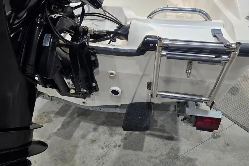 Slide: The Image of 1999 Boston Whaler Dauntless 14 boat stern with motor and ladder. - 40