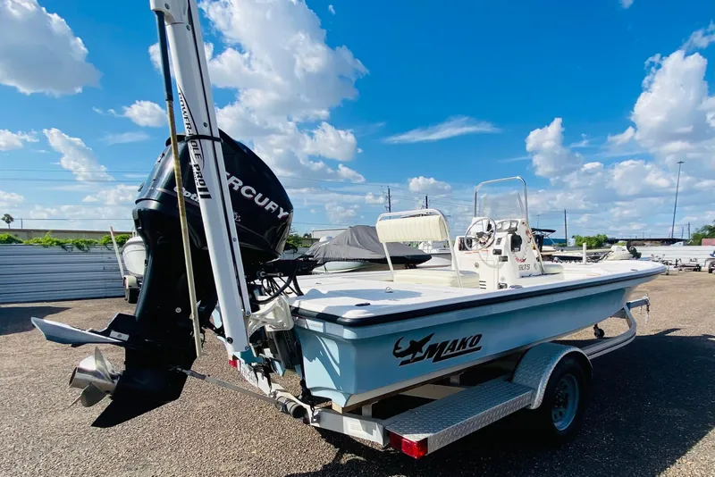 Slide: The Image of 2013 Mako 18 LTS boat on trailer, featuring Mercury outboard motor, under a clear blue sky. - 3