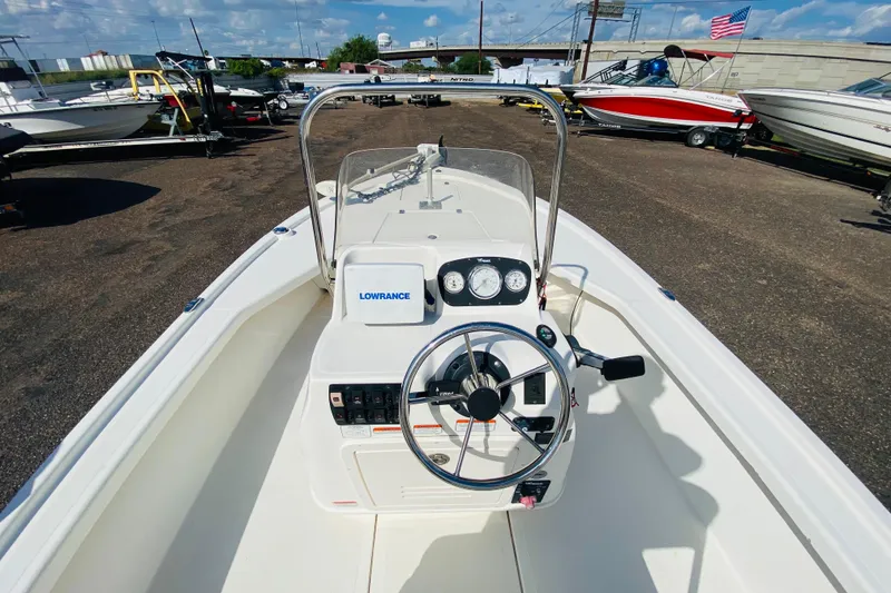 Slide: The Image of 2013 Mako 18 LTS boat dashboard with steering wheel and Lowrance navigation system. - 8